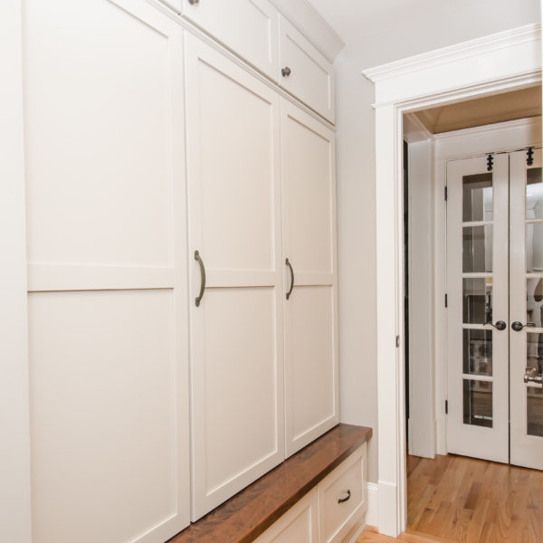 custom-designed mudroom in Dunwoody home with white cabinets for backpacks school supplies and sports equipment
