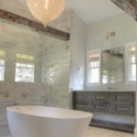 transitional bathroom renovation with large walk-in shower for two and large soaking tub with grey vanity and exposed beams