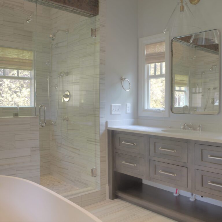 transitional bathroom renovation with large walk-in shower for two and large soaking tub with grey vanity and exposed beams