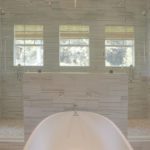 transitional bathroom renovation with large walk-in shower for two and large soaking tub with grey vanity and exposed beams