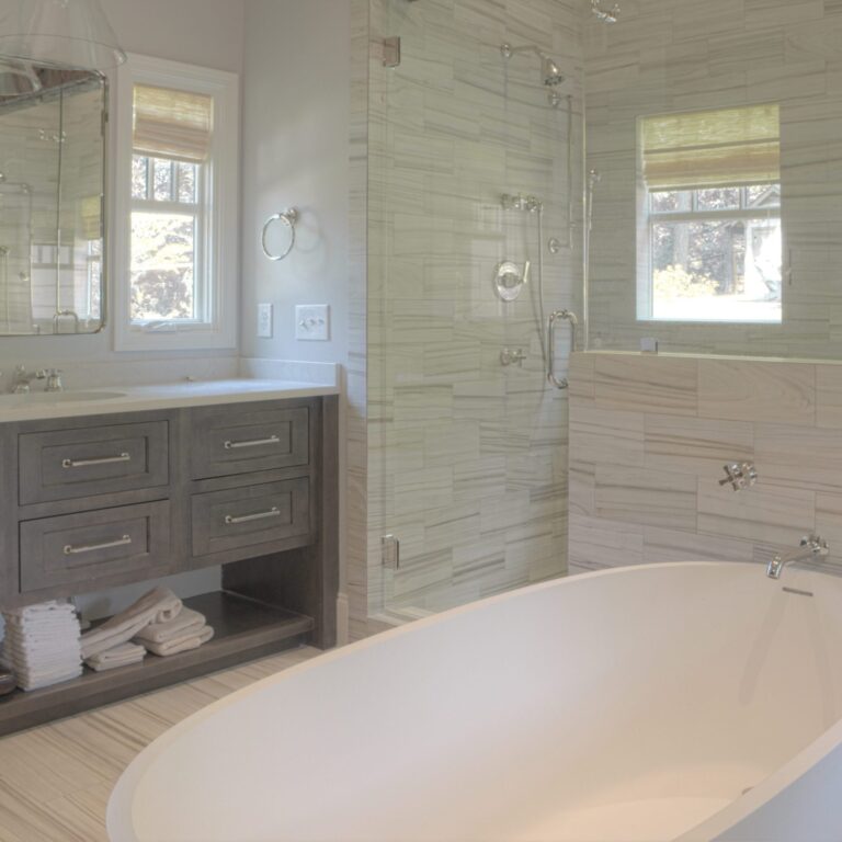 transitional bathroom renovation with large walk-in shower for two and large soaking tub with grey vanity and exposed beams