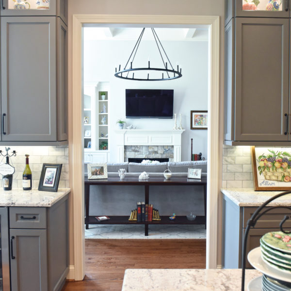 kitchen renovation with grey painted cabinets contrasting dark stained wood island luxury appliances