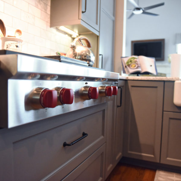 kitchen renovation with grey painted cabinets contrasting dark stained wood island luxury appliances