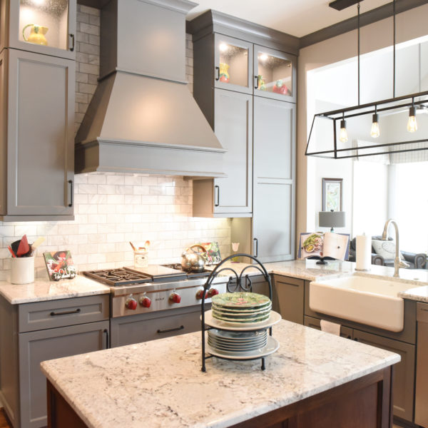 kitchen renovation with grey painted cabinets contrasting dark stained wood island luxury appliances