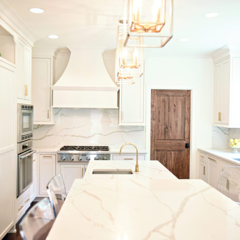 exquisite Atlanta kitchen renovation with custom white cabinets large island with seating and luxury appliances