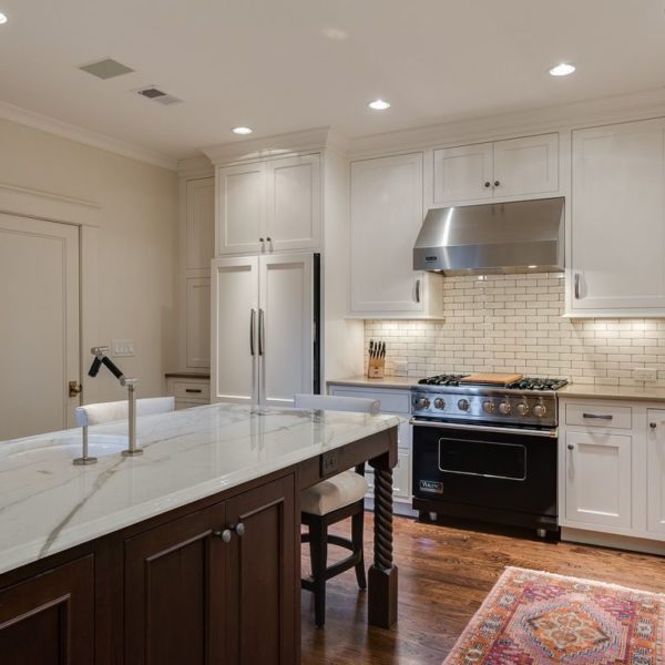 elegant transitional kitchen with white cabinets subway tile dark island stainless steel appliances farmhouse sink