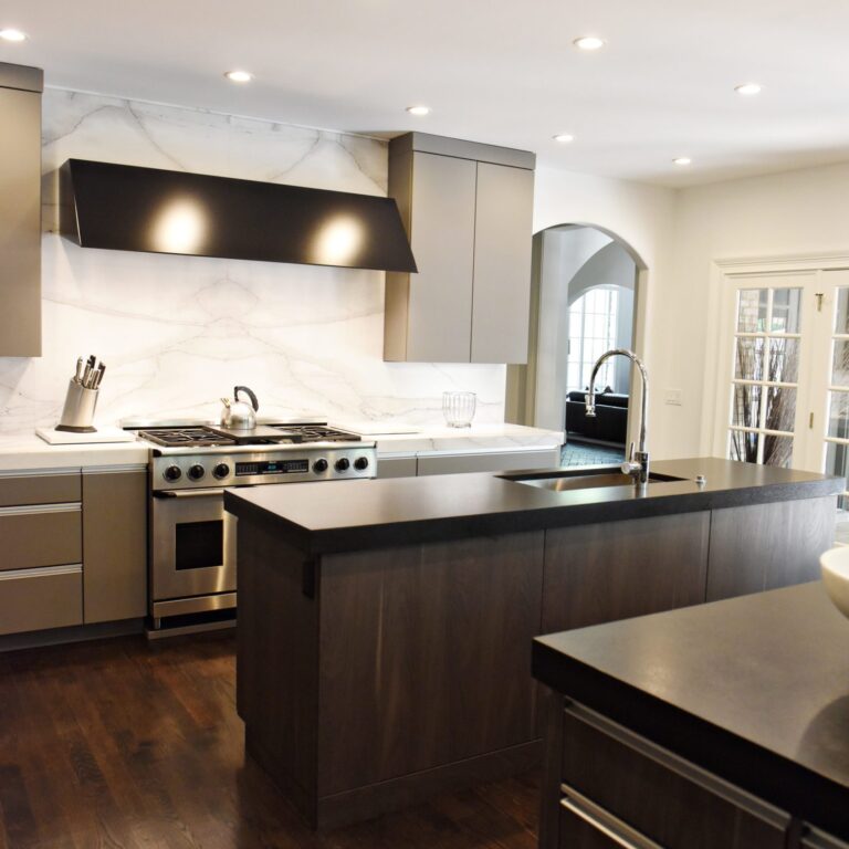 kitchen renovation with modern grey cabinets and dark wood cabinets featuring two islands and luxury appliances including two dishwashers