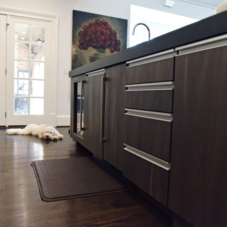 kitchen renovation with modern grey cabinets and dark wood cabinets featuring two islands and luxury appliances including two dishwashers