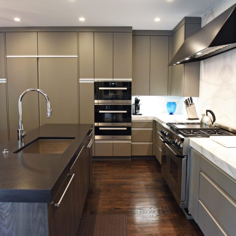 kitchen renovation with modern grey cabinets and dark wood cabinets featuring two islands and luxury appliances including two dishwashers