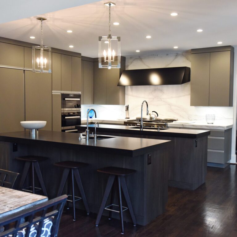 kitchen renovation with modern grey cabinets and dark wood cabinets featuring two islands and luxury appliances including two dishwashers