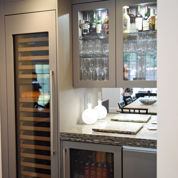 kitchen renovation with modern grey cabinets and dark wood cabinets featuring two islands and luxury appliances including two dishwashers