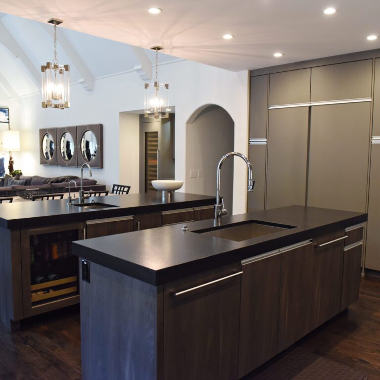 kitchen renovation with modern grey cabinets and dark wood cabinets featuring two islands and luxury appliances including two dishwashers