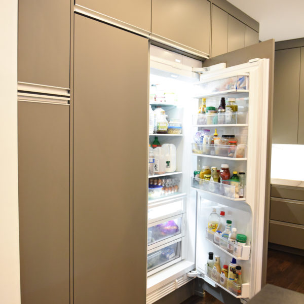 kitchen renovation with modern grey cabinets and dark wood cabinets featuring two islands and luxury appliances including two dishwashers