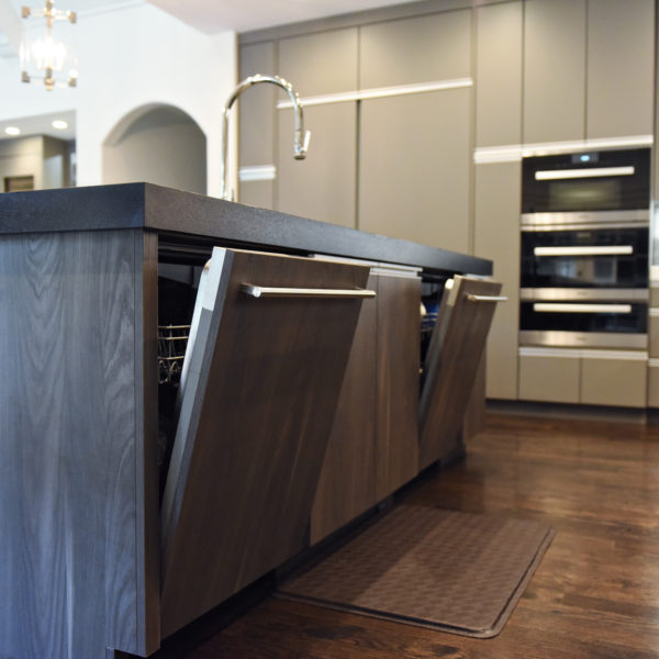 kitchen renovation with modern grey cabinets and dark wood cabinets featuring two islands and luxury appliances including two dishwashers