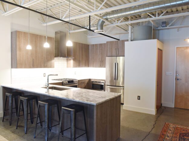 modern kitchen design in loft building with industrial ceiling