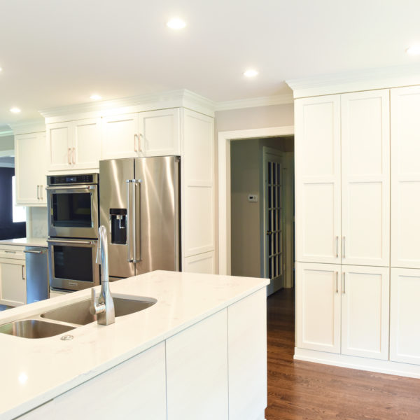 Atlanta area kitchen transformation with white cabinets luxury appliances breakfast nook and custom storage tower and pantry cabinets