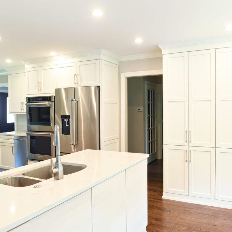 Atlanta area kitchen transformation with white cabinets luxury appliances breakfast nook and custom storage tower and pantry cabinets