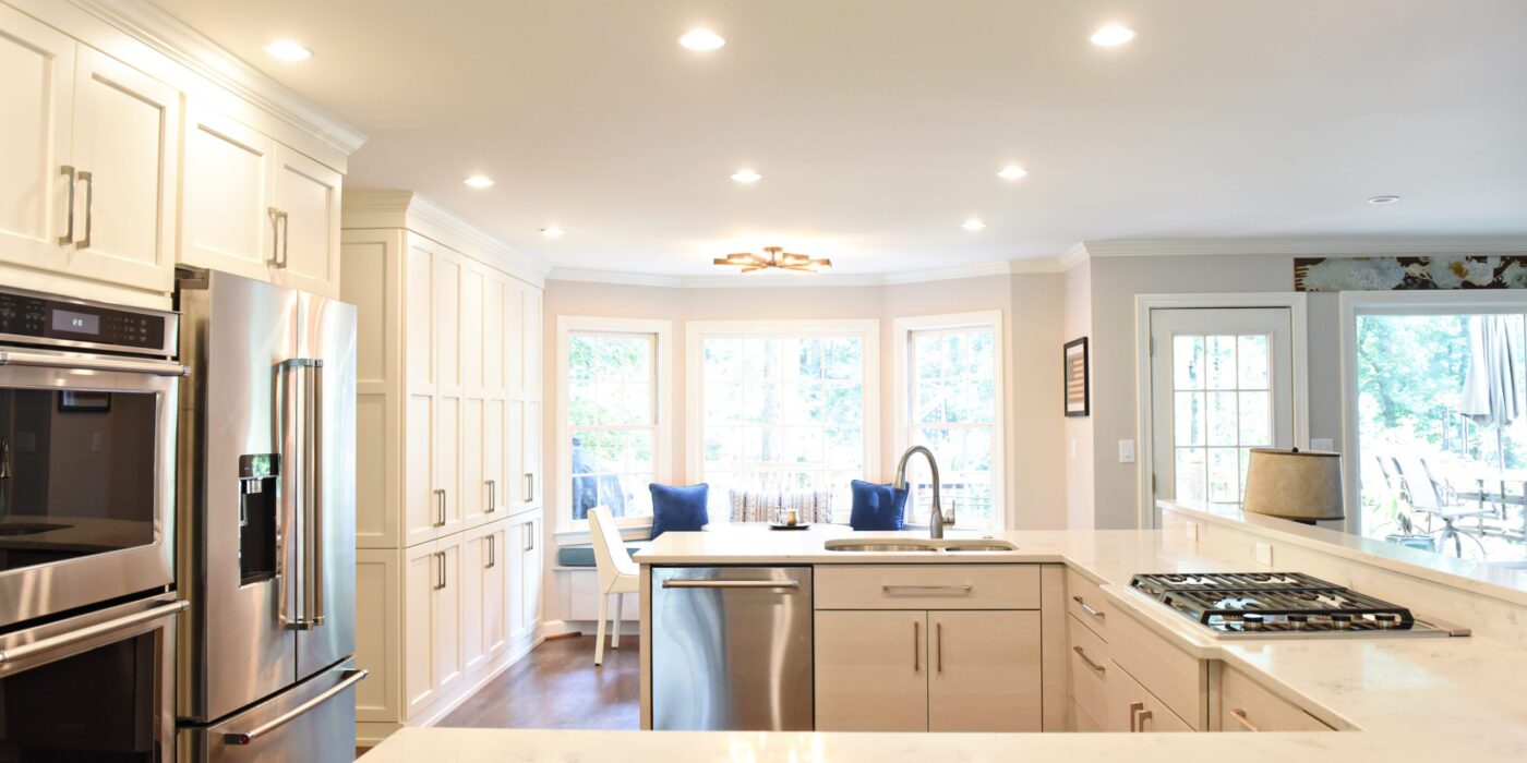 Atlanta area kitchen transformation with white cabinets luxury appliances breakfast nook and custom storage tower and pantry cabinets