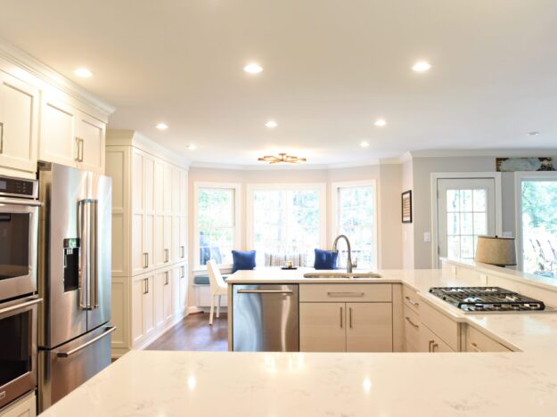 Atlanta area kitchen transformation with white cabinets luxury appliances breakfast nook and custom storage tower and pantry cabinets