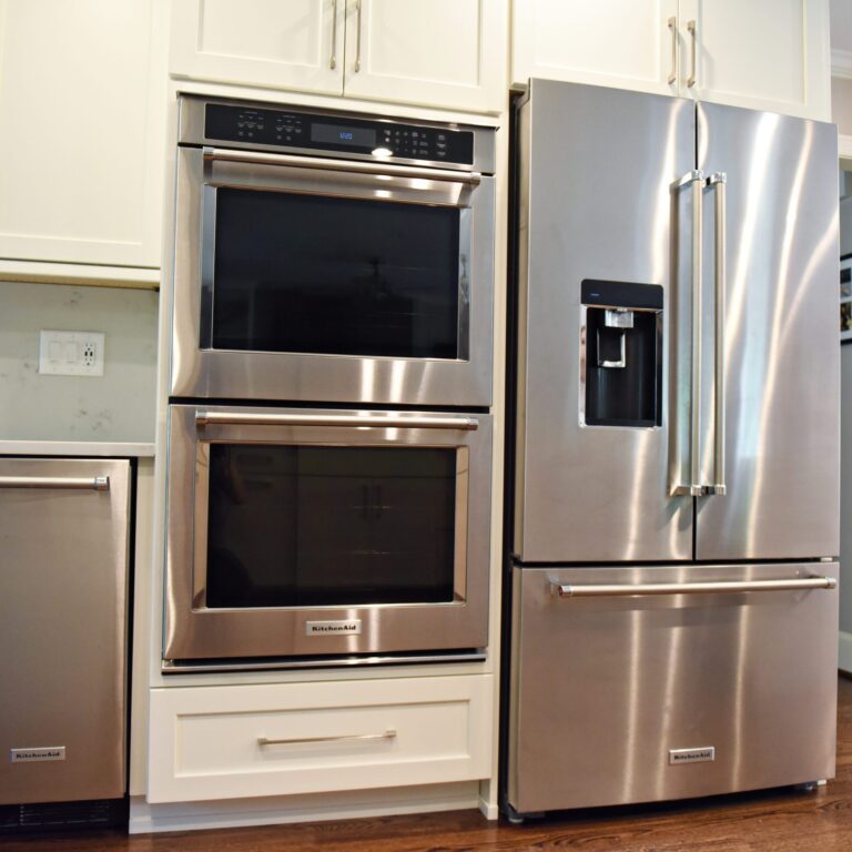 Atlanta area kitchen transformation with white cabinets luxury appliances breakfast nook and custom storage tower and pantry cabinets