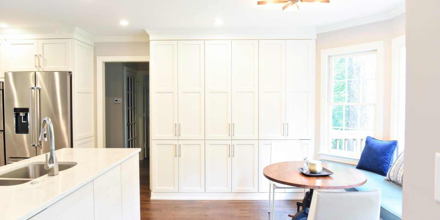 Atlanta area kitchen transformation with white cabinets luxury appliances breakfast nook and custom storage tower and pantry cabinets