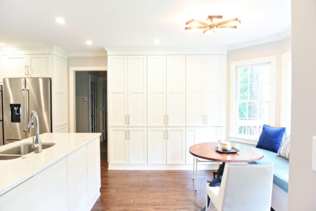 Atlanta area kitchen transformation with white cabinets luxury appliances breakfast nook and custom storage tower and pantry cabinets