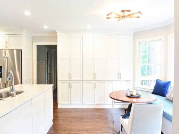 Atlanta area kitchen transformation with white cabinets luxury appliances breakfast nook and custom storage tower and pantry cabinets