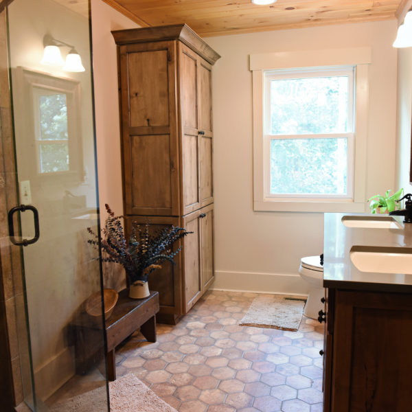 Rustic retreat bathroom design modern mountain cabin bathroom with walk-in shower double vanity and large storage tower cabinet