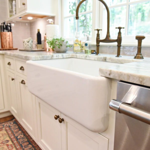 transitional Atlanta kitchen with white cabinets grey island luxury stainless steel appliances farmhouse sink