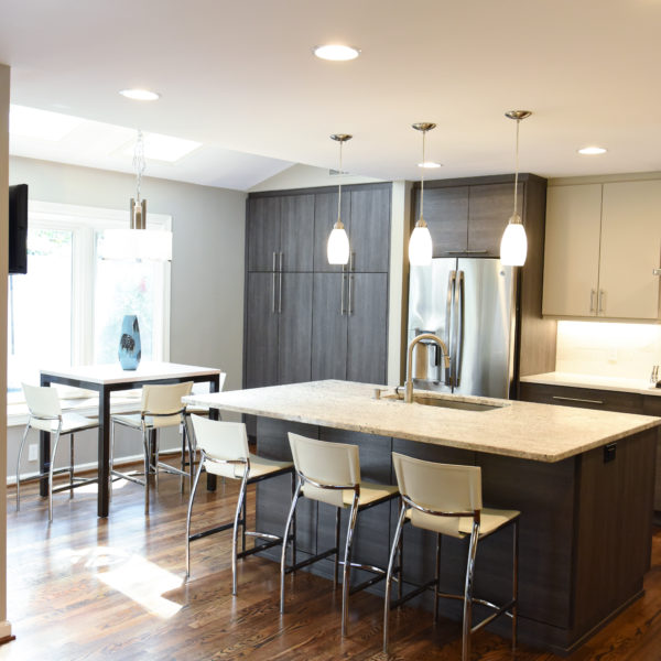 modern Atlanta kitchen design with dark contemporary lower cabinets and lighter upper cabinets with large island and luxury stainless steel appliances