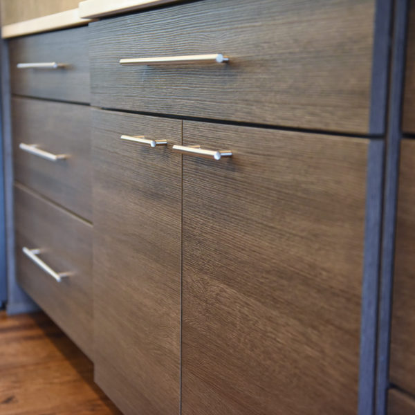 modern Atlanta kitchen design with dark contemporary lower cabinets and lighter upper cabinets with large island and luxury stainless steel appliances