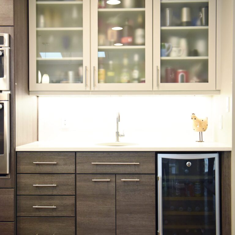 modern Atlanta kitchen design with dark contemporary lower cabinets and lighter upper cabinets with large island and luxury stainless steel appliances