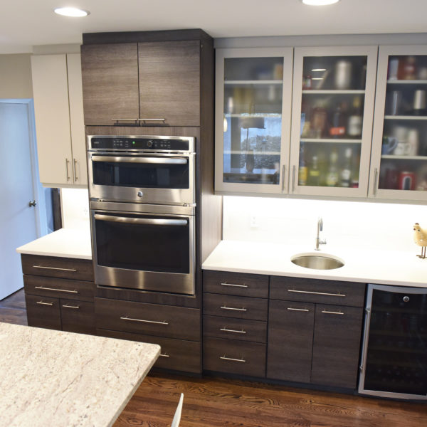 modern Atlanta kitchen design with dark contemporary lower cabinets and lighter upper cabinets with large island and luxury stainless steel appliances