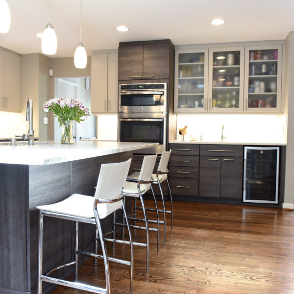 modern Atlanta kitchen design with dark contemporary lower cabinets and lighter upper cabinets with large island and luxury stainless steel appliances