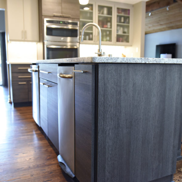 modern Atlanta kitchen design with dark contemporary lower cabinets and lighter upper cabinets with large island and luxury stainless steel appliances