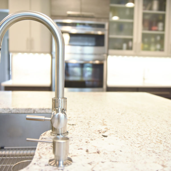 modern Atlanta kitchen design with dark contemporary lower cabinets and lighter upper cabinets with large island and luxury stainless steel appliances