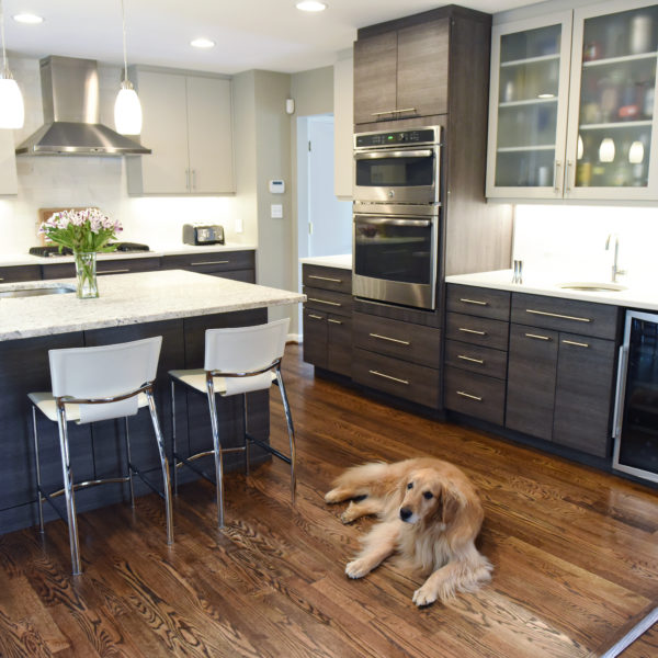 modern Atlanta kitchen design with dark contemporary lower cabinets and lighter upper cabinets with large island and luxury stainless steel appliances