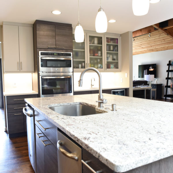 modern Atlanta kitchen design with dark contemporary lower cabinets and lighter upper cabinets with large island and luxury stainless steel appliances