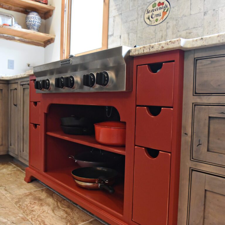 rustic kitchen renovation with custom grey cabinets large island with seating for four red pops of color on accent cabinets floating shelves exposed beams