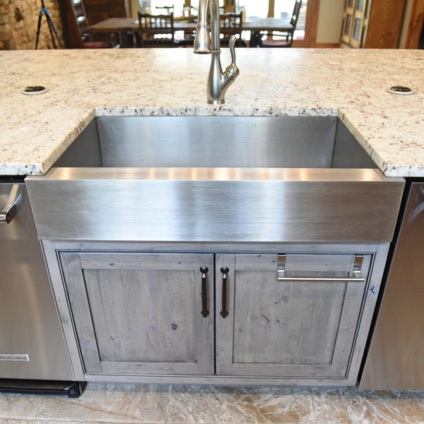 rustic kitchen renovation with custom grey cabinets large island with seating for four red pops of color on accent cabinets floating shelves exposed beams