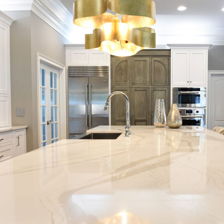close up of countertop in kitchen renovation Johns Creek GA with stainless steel appliances white cabinets grey island marble countertops