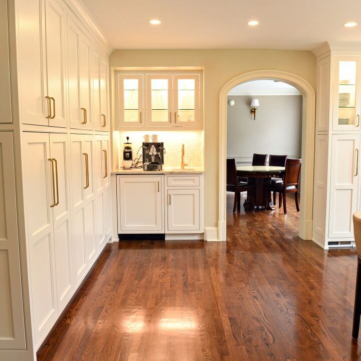 view to coffee bar in award-winning Atlanta kitchen features white custom curved base cabinets with elegant curved contrasting dark island