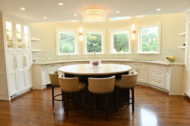 award-winning Atlanta kitchen features white custom curved base cabinets with elegant curved contrasting dark island
