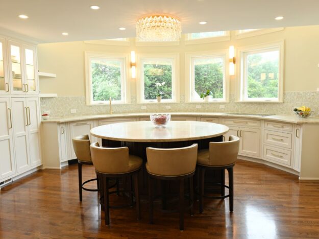 award-winning Atlanta kitchen features white custom curved base cabinets with elegant curved contrasting dark island