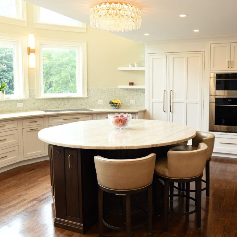 award-winning Atlanta kitchen features white custom curved base cabinets with elegant curved contrasting dark island