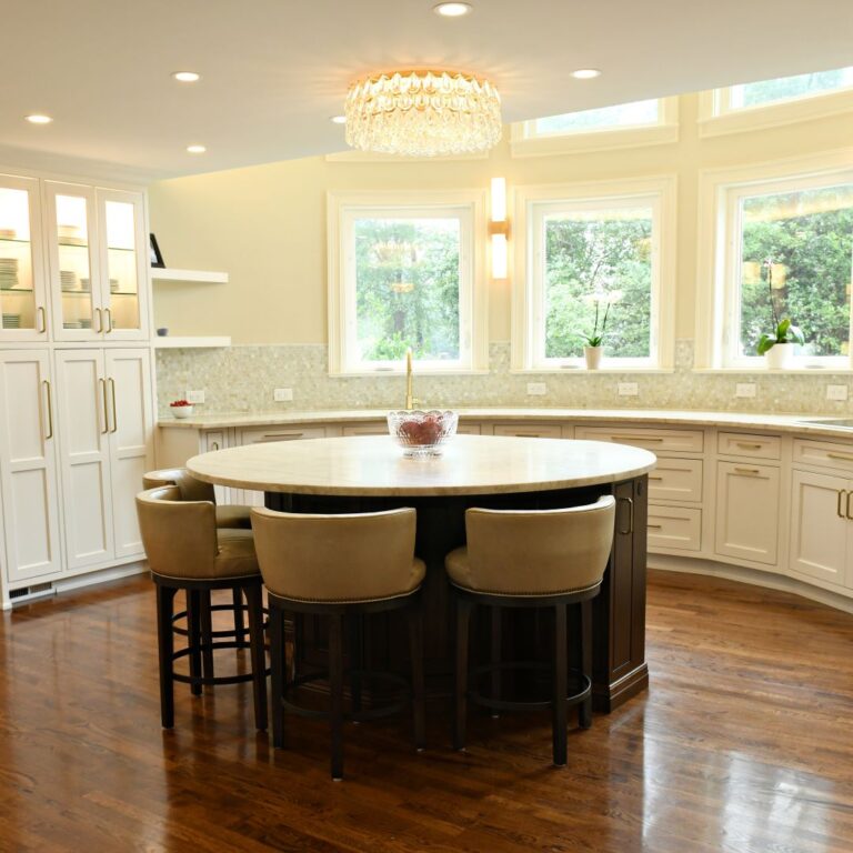 award-winning Atlanta kitchen features white custom curved base cabinets with elegant curved contrasting dark island