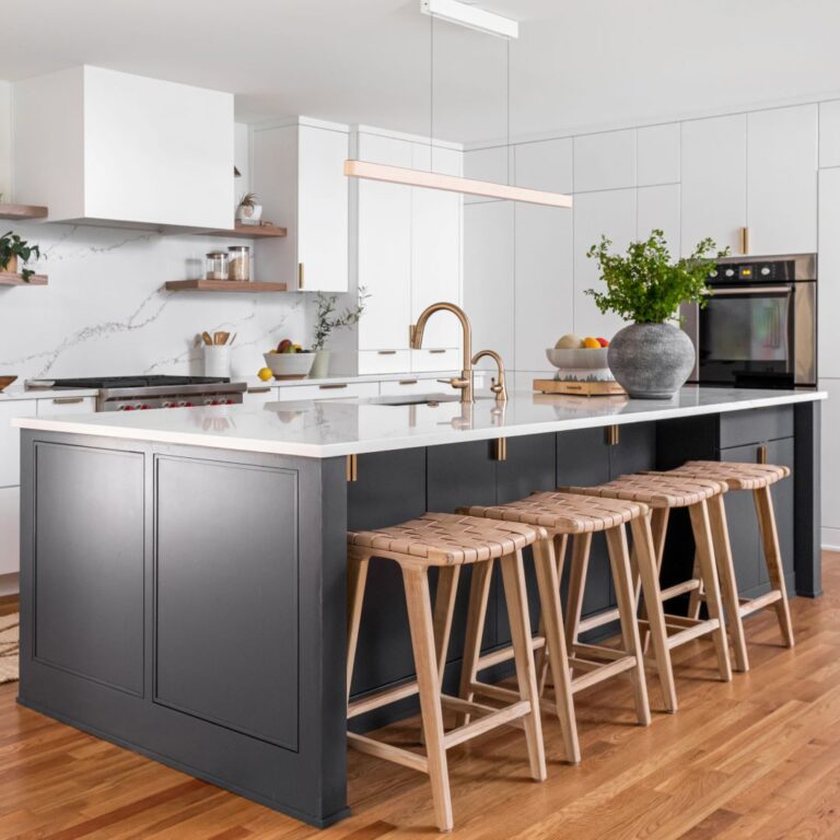 the dark blue kitchen island offers ample storage and serves as a beautiful contrast to the white wall and floor cabinets in this gorgeous modern Atlanta kitchen remodel