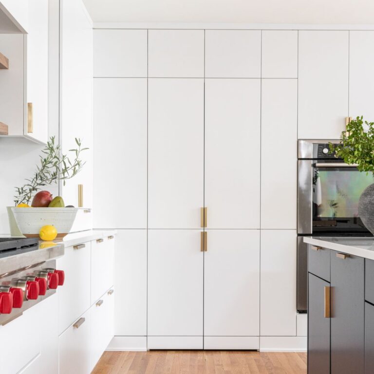contemporary atlanta kitchen renovation features sleek white cabinets with gold hardware and lots of custom storage space