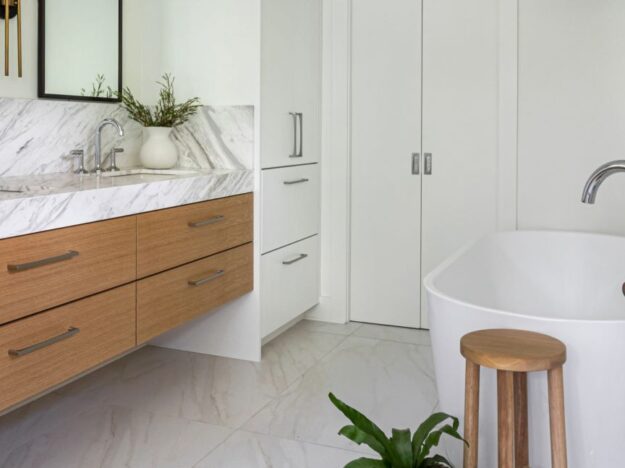 this spa-like Atlanta bath renovation features a soaking tub walk-in shower custom floating cabinets and custom storage tower