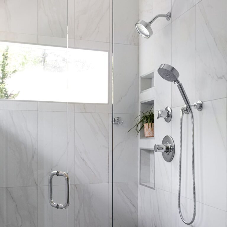 close up of shower fixtures in spa-like Atlanta bath renovation with a soaking tub walk-in shower custom floating cabinets and custom storage tower